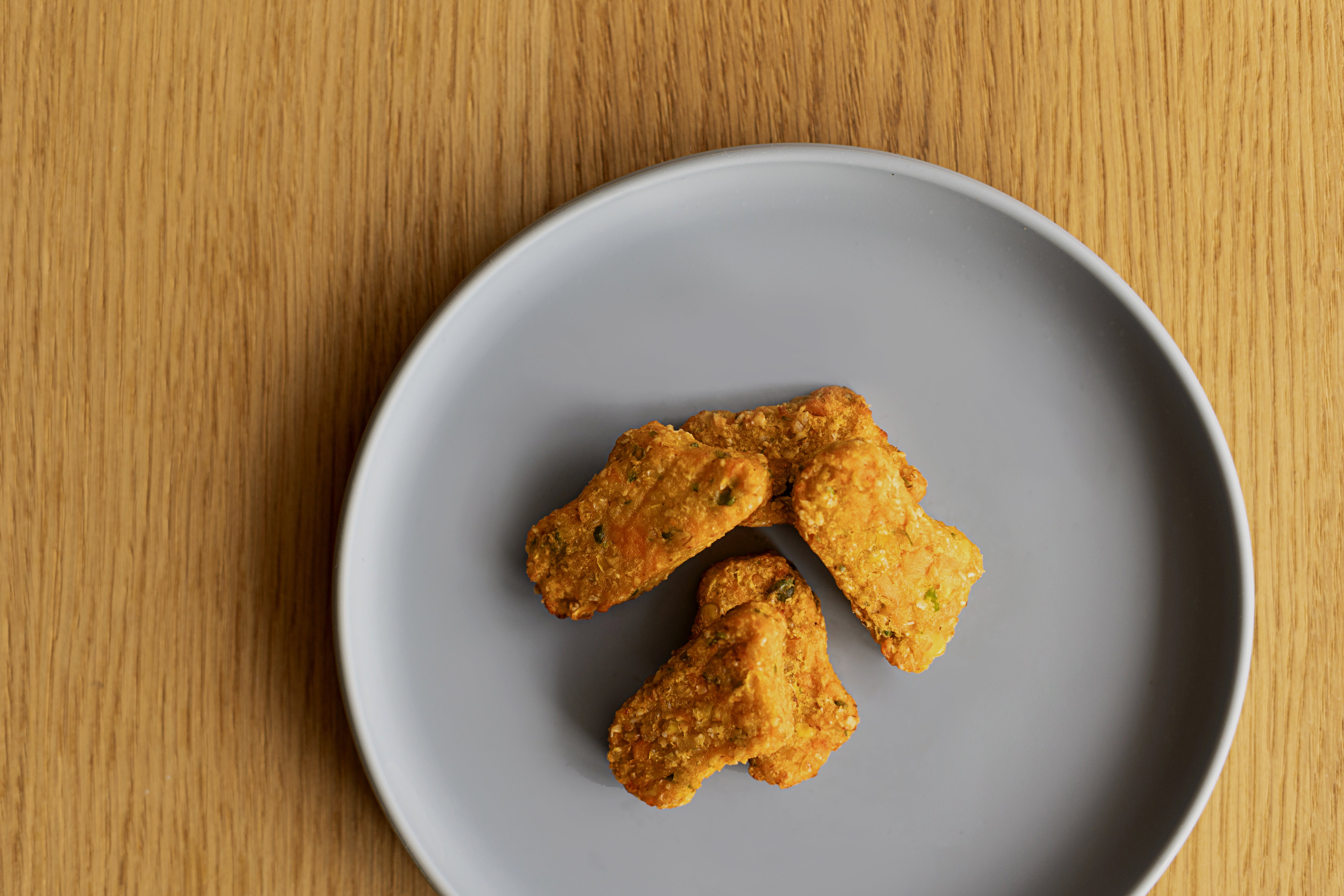 breifreie Gemüse Süßkartoffel Erbsen Nuggets für Babys ab 18 Monaten auf Babyteller angerichtet